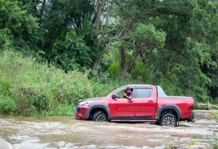 A car travelling in a shallow river